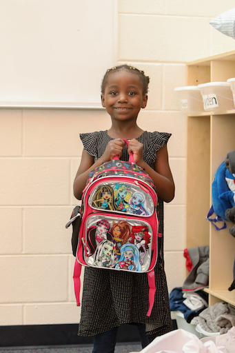 Student posing with backpack